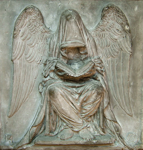Relief carving of Fate reading destiny in a book.